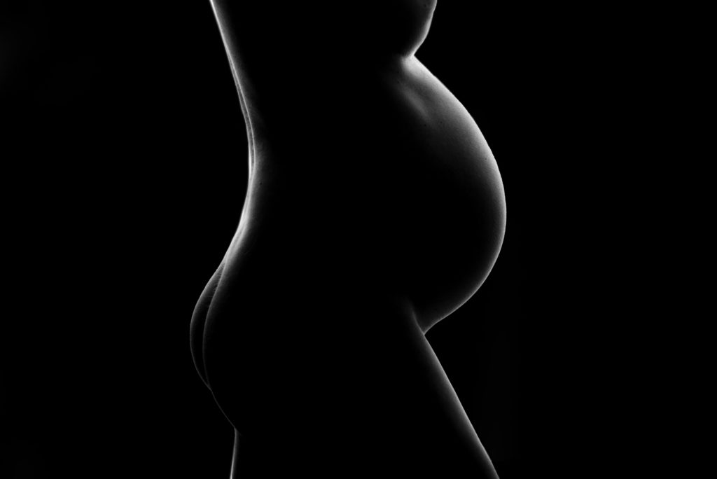 Silhouette of pregnant women's body. 