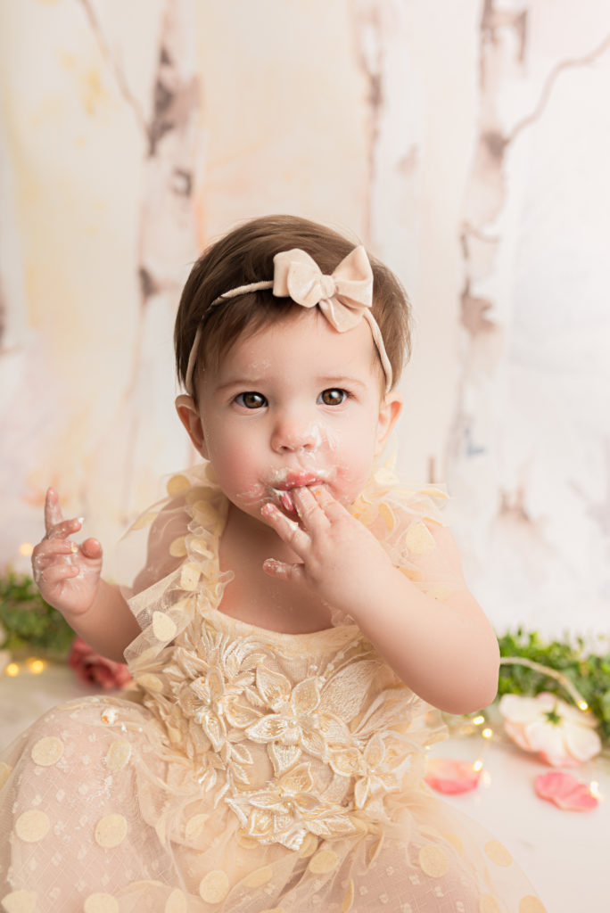 One year old eating cake at charlotte one year cake smash session