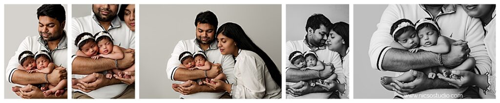 Collage of 5 photos showing dad holding twin girls during their twin newborn photoshoot on a white backdrop wearing white. Mom is in them as well coming from the right side holding babies feet and looking down towards hem on to her husband touching noses. 