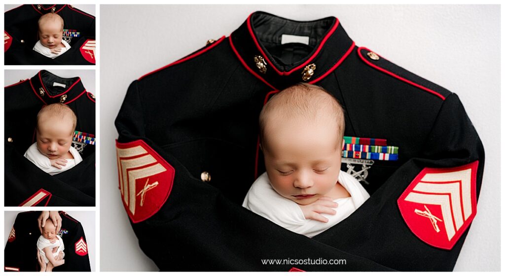 Baby boy laying on top of marine corps dress blues with the sleeves hugging the newborn during his newborn session. 