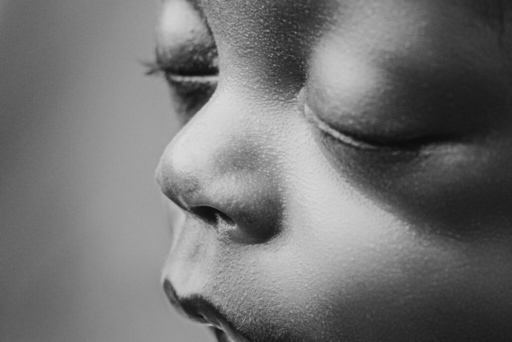 Black and white macro detail of a preemie newborn’s nose and closed eye, photographed at NicSo Studio for a timeless Charlotte newborn portrait.